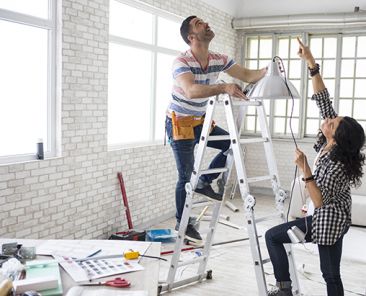Young woman and a construction worker renovating an apartment.
